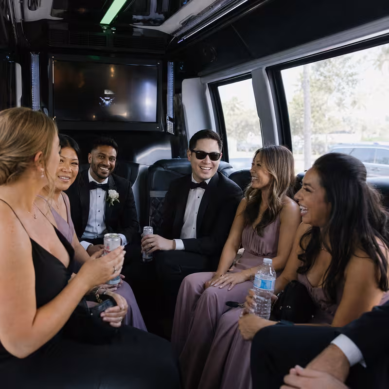 Wedding guests seated inside a San Diego party bus