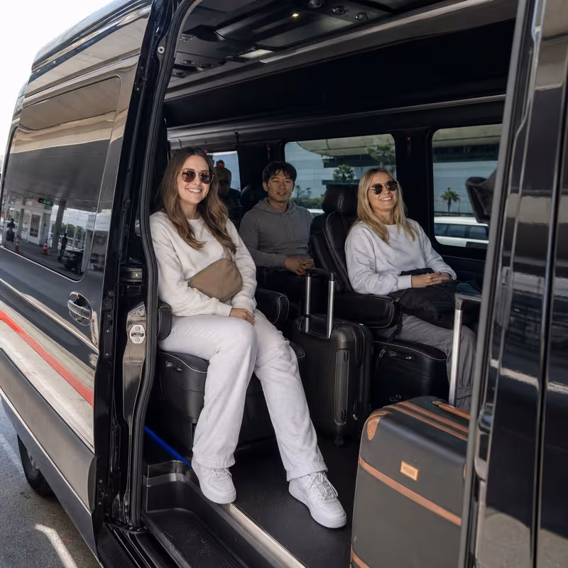 Passengers loading luggage while boarding an San Diego group shuttle