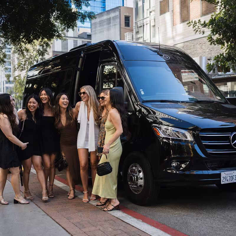 Group boarding a white charter bus for Bachelor & Bachelorette Transportation transportation in San Diego