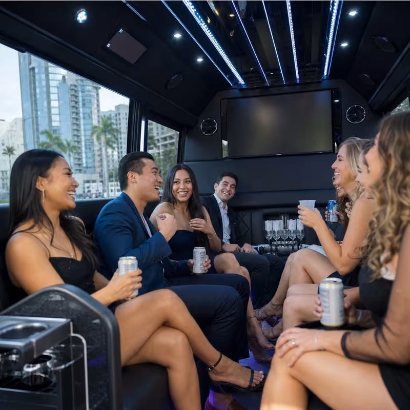 Party bus interior with wraparound leather seating and LED lighting in San Diego