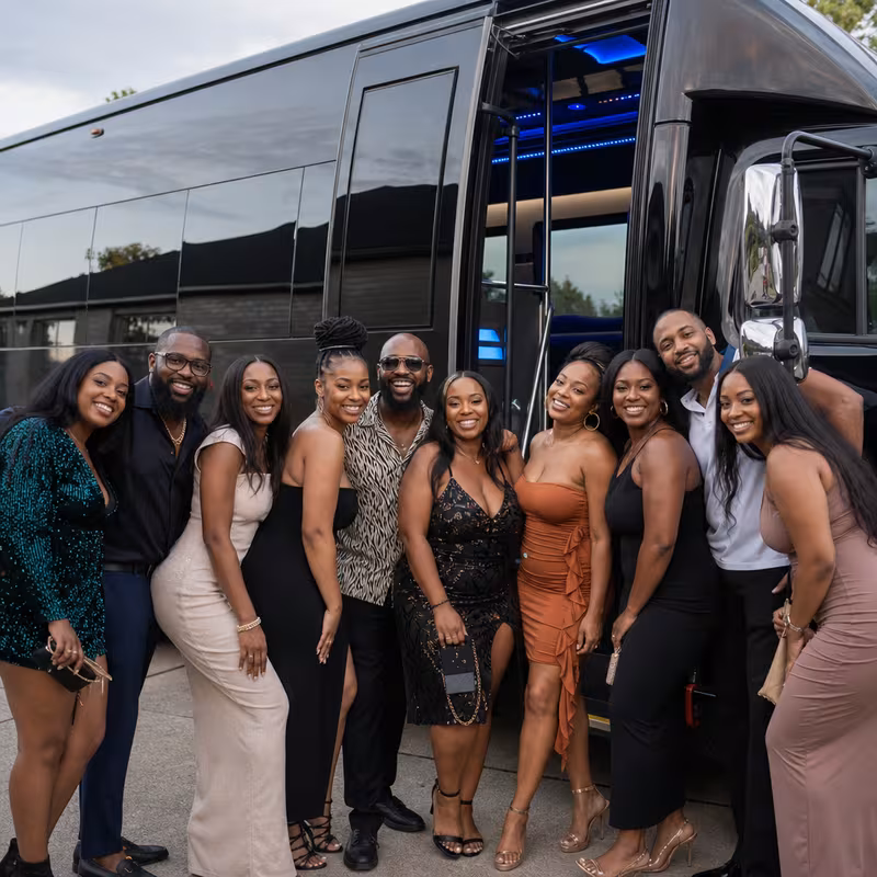 Group boarding a white charter bus for Birthday Transportation transportation in San Diego
