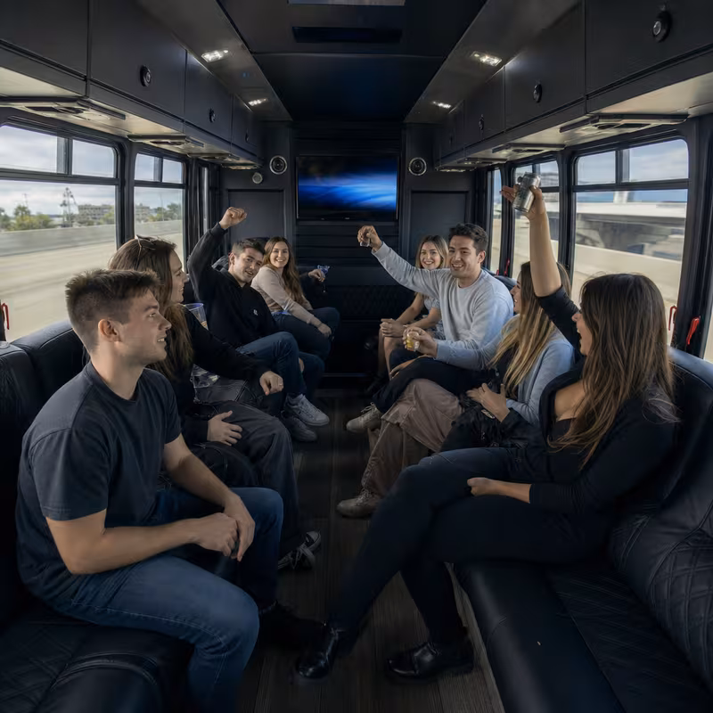 Group boarding a white charter bus for Concert Transportation transportation in San Diego