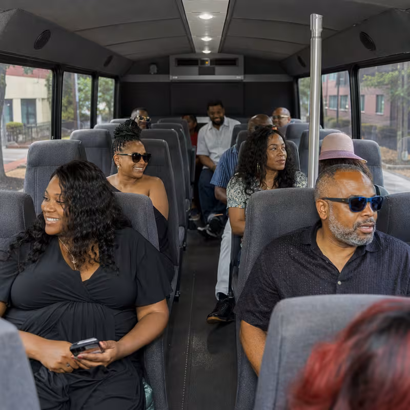 Group boarding a white charter bus for Private Event Transportation transportation in San Diego
