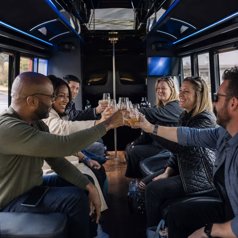 Group boarding a white charter bus for Winery & Brewery Tour Transportation transportation in San Diego