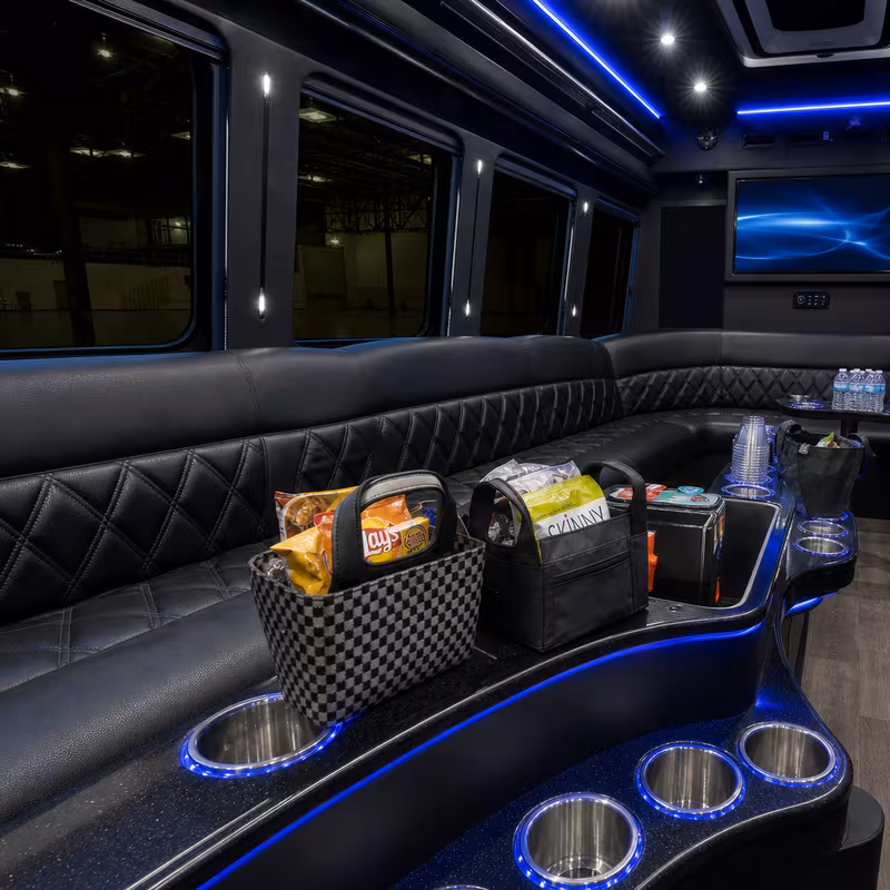 Party bus interior with wraparound leather seating and LED lighting in San Diego